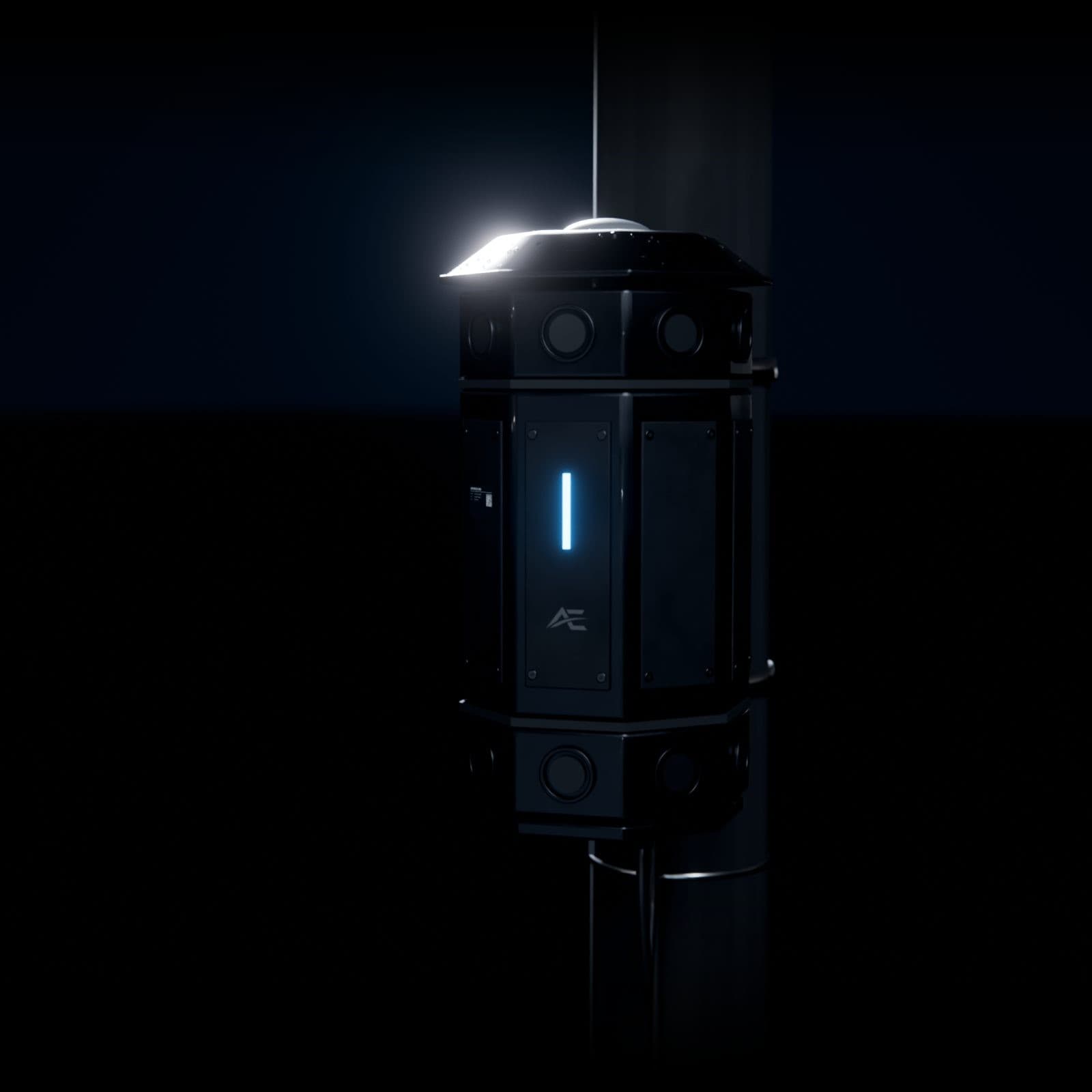 The sensor package close up, an octagonal housing with microphone ports around its top and bottom, strapped to a pole